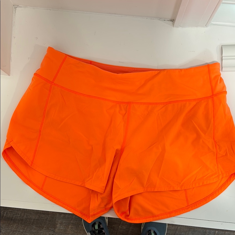 Lululemon orange mid-rise running shorts size 10